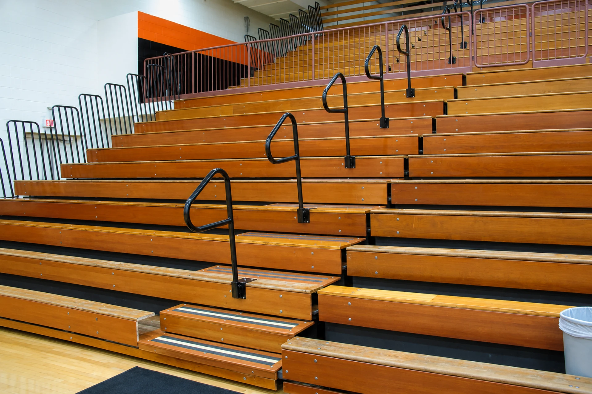 empty wooden bleachers in a school gymnasium